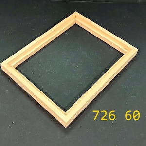 May include: A rectangular light-colored wooden picture frame with a stepped inner edge profile. The frame is empty and features the yellow text 726 60 printed in the lower right corner, indicating the specific model or style number of the item.