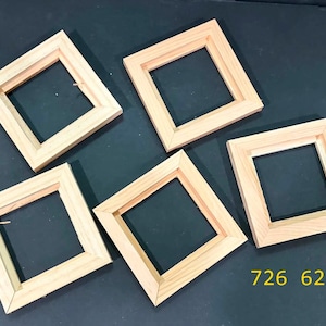 May include: Five square, light-colored wooden frames arranged in a cluster. Each frame features a simple, flat-profile design with mitered corners. The yellow text 726 62 is visible in the lower right corner of the image area.