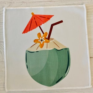 May include: A green coconut with a yellow flower and a red umbrella on top. The coconut has a straw sticking out of the top.