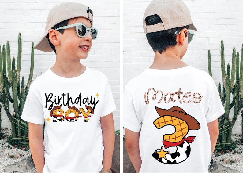 May include: White t-shirt with "Birthday Boy" text and cowboy-themed graphics. The back of the shirt has the name "Mateo" and a number 3 with a cowboy hat and sheriff's badge. The shirt is designed for a child's birthday.
