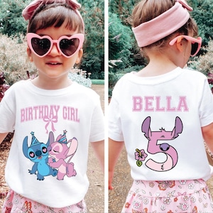 May include: White t-shirt with a cartoon graphic of Stitch and Angel, and the text "BIRTHDAY GIRL" in pink. The back of the shirt has the name "BELLA" and the number "5" with Stitch. The child is wearing pink heart-shaped sunglasses.