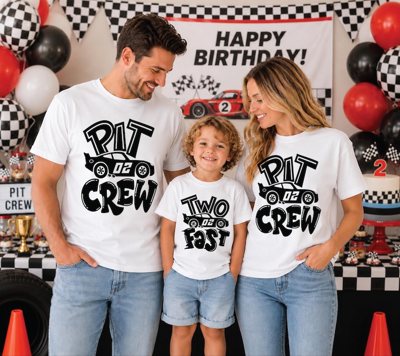May include: Three white t-shirts featuring black graphic prints. Two shirts display the text PIT CREW with a race car graphic, while the smaller shirt displays the text TWO FAST with a race car graphic. All shirts feature the number 02 on the cars.