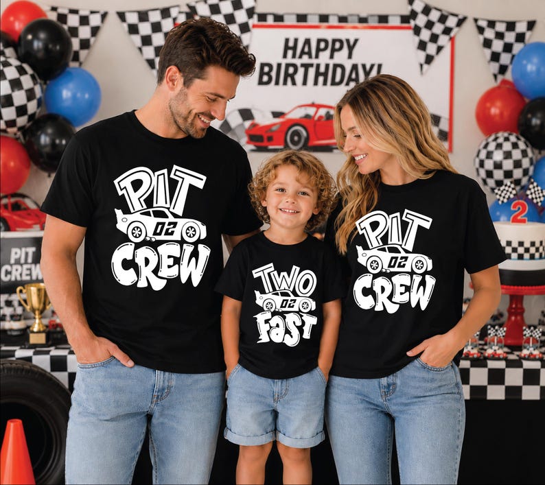 May include: Three black t-shirts featuring white graphic prints. Two shirts display the text "PIT CREW" with a race car graphic labeled "02". One shirt displays the text "TWO FAST" with a race car graphic labeled "02".