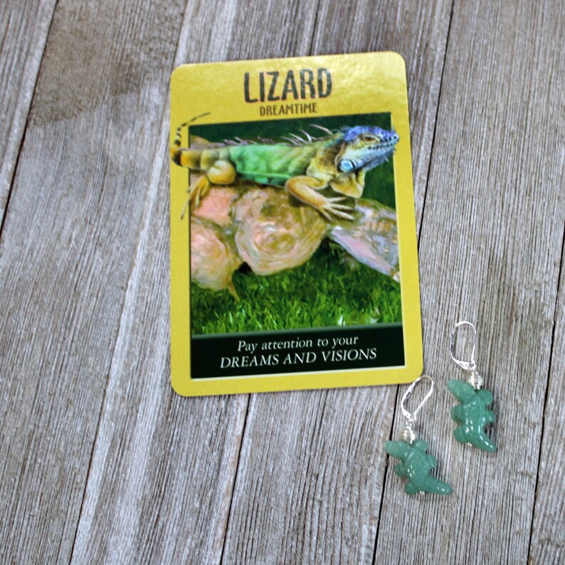 May include: Green and blue lizard on a yellow card with the text "Lizard Dreamtime" and "Pay attention to your DREAMS AND VISIONS".  Two green lizard shaped earrings with silver hooks.