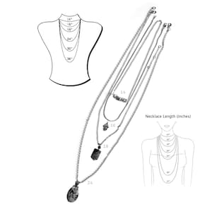 May include: A set of four silver chain necklaces with different pendant styles. The necklaces are layered and shown on a mannequin. The necklaces are available in lengths of 14, 16, 18, and 24 inches.