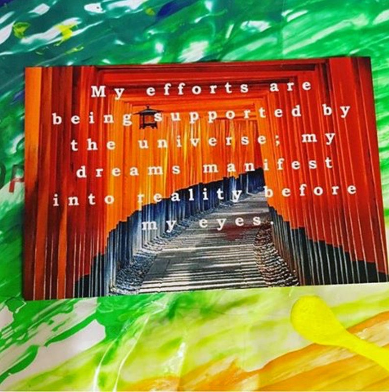 May include: A motivational quote about dreams manifesting into reality, displayed against a backdrop of a vibrant orange and red Japanese gate.