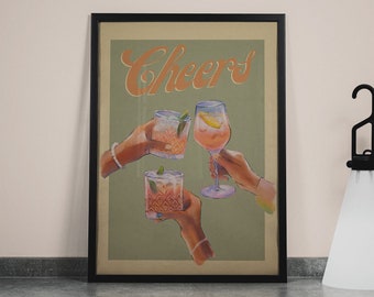 May include: A framed print with a green background and the word "Cheers" in orange script. Three hands are holding up glasses of pink and orange cocktails.