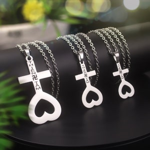 May include: Three silver necklaces with heart-shaped cross pendants. Each pendant has the inscription "THIEN TAM" in a stylized font.