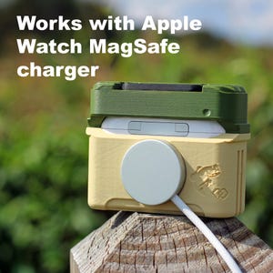 May include: A two-tone case for an Apple Watch MagSafe charger. The case is olive green and light yellow with a white charging disc and cable. The text "Works with Apple Watch MagSafe charger" is at the top.