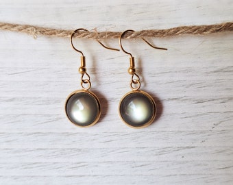 May include: A pair of gold dangle earrings with round, iridescent gray glass stones.