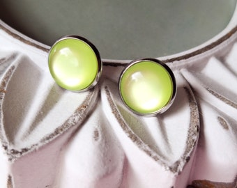 May include: A pair of silver stud earrings with a light green iridescent cabochon.