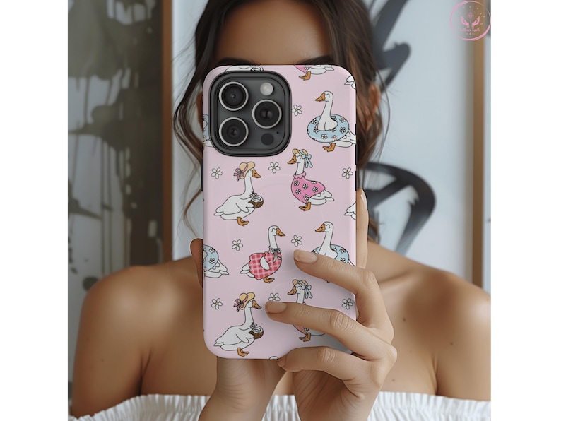 Whimsical summer geese phone case featuring pastel pink background, cottagecore aesthetic, daisies, coquette vibes, floral charm, vintage-inspired design, gingham dresses, daisy lifebuoys, coconut drinks, ribbons, feminine style, nature-inspired art, dreamy pastel colors, aesthetic accessories, playful summer theme, MagSafe compatibility, trendy design, botanical whimsy, English garden feel, charming and delicate vibes, perfect for fashion-forward phone case lovers.