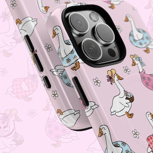 Pastel pink phone case featuring whimsical geese in summer outfits, pink gingham, daisies, coquette aesthetic, cottagecore vibes, retro floral design, vintage charm, dreamy summer style, ribbon bows, botanical patterns, playful aesthetic, nature-inspired, trendy MagSafe case, chic phone accessory, cute animal design, feminine aesthetic, modern summer fashion, ideal for aesthetic lovers, whimsical decor, cottagecore accessories, trendy pastel phone case for summer vibes.