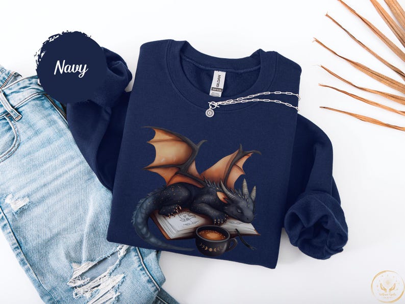 Cozy sweatshirt with cute black dragon sleeping on book on dragonkind with mug of coffee with moon phase pattern. Fourth wing Tairn Andarna dragons bookish booktok bookstagram  fantasy fan reader romantasy coffee lover gift idea soft warm sweater GOT