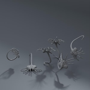 May include: A group of six gray alien-like creatures with long, spindly legs and segmented bodies. The creatures are posed in various positions, some with their legs extended and others with their legs curled up.