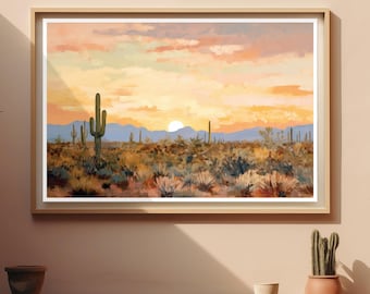 Op de afbeelding: Een ingelijste landschapsafdruk met een woestijnscène bij zonsondergang. Het kunstwerk toont een felle zon laag aan de horizon, silhouetten van bergen en diverse cactussen verspreid over een voorgrond van droge, textuurrijke struiken in oranje en bruin.