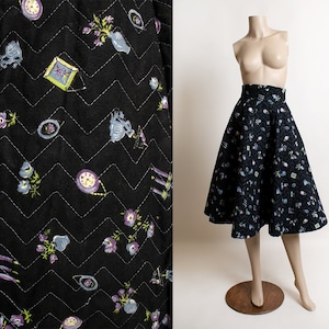 May include: A black quilted skirt with a floral print. The skirt is full and has a high waist. It is made of a soft, comfortable fabric.