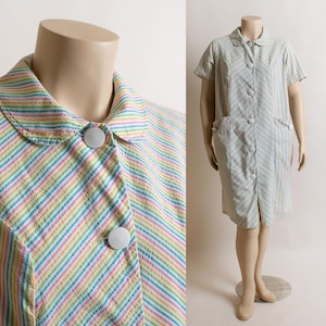 May include: Two striped dresses with white buttons. The dress on the left has a rainbow stripe pattern. The dress on the right has a light blue and white stripe pattern.