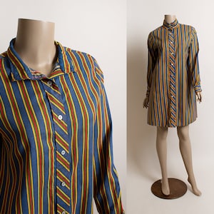 May include: A long-sleeved shirt dress with blue, yellow, and red stripes. The dress has a collared neckline and button closure.