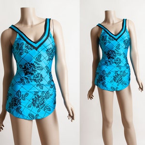 May include: A vintage one-piece swimsuit with a blue and black floral pattern. The swimsuit has a V-neckline and a fitted silhouette.