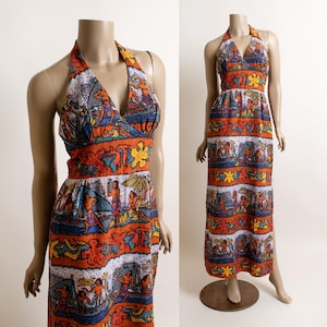 May include: A vintage halter-neck maxi dress featuring a vibrant tropical print. The dress showcases a V-neckline and a fitted bodice with a wide waistband. The colorful pattern includes figures, flowers, and beach scenes in shades of orange, blue, and yellow.