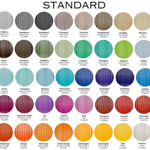 May include: A color chart with 48 different colors of plastic filament. Each color is labeled with its name and a corresponding color code. The colors are arranged in rows and columns, and the chart is titled "STANDARD".