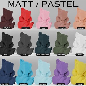 May include: A collection of 15 small, hand-painted figurines in various colors, including red, pink, black, gray, green, white, blue, and yellow. Each figurine is in the shape of a cartoon animal with a curled tail and a sleeping expression. The figurines are arranged in three rows of five, with the colors of each row changing from left to right. The text "MATT / PASTEL" is displayed at the top of the image.