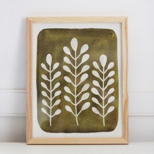May include: A framed print with a green background and white stylized floral design. The print features three branches with leaves.