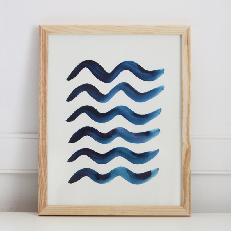May include: A framed print with a white background and five blue watercolor waves.