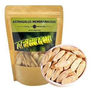 May include: A brown paper bag of Astragalus Membranaceus herbal tea with a clear window showing the tea inside. A white bowl filled with sliced astragalus root is next to the bag. The bag has a green label with the text "Astragalus Membranaceus".