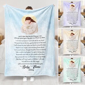 May include: A light blue fleece blanket with a religious image of Jesus holding a baby. The blanket has a poem about a baby who has passed away. The poem includes the text "and to think that the first thing you saw when you opened your tiny eyes was the face of Jesus." The blanket also has the text "Baby Name 2024".