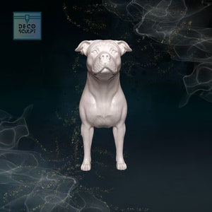 May include: A white, 3D printed figurine of a Staffordshire Bull Terrier standing on a dark blue background. The dog is looking directly at the camera.