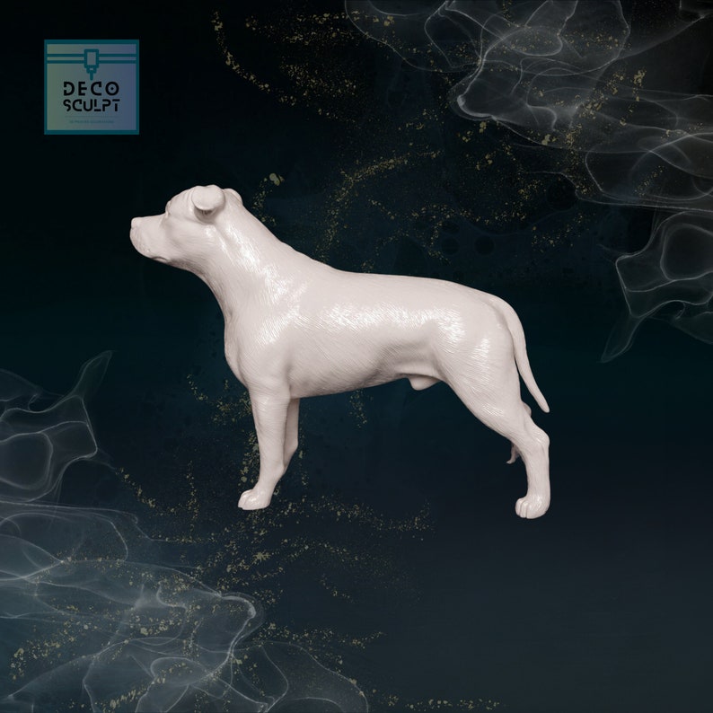 May include: White ceramic figurine of a Staffordshire Bull Terrier dog standing in profile. The figurine is detailed with fur texture and is posed with its head turned to the side.