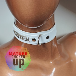 May include: White leather choker with silver metal accents and the word "Kitten" spelled out on the front.