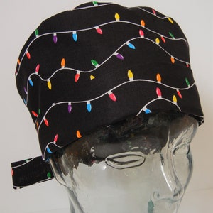May include: Black scrub hat with a colorful string of lights pattern.
