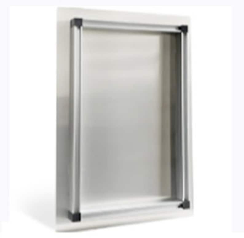 May include: A silver metal picture frame with a rectangular opening. The frame has a simple, modern design and is made of a brushed metal.