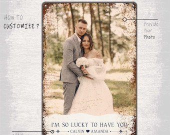 May include: A personalized metal sign with a rustic background featuring a wedding photo of a couple. The sign reads "I'm so lucky to have you" with the couple's names "Calvin" and "Amanda" below.