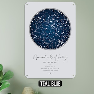May include: Teal blue metal sign featuring a dark blue celestial map within a circular frame. The sign includes the names "Amanda & Harry", the date, and location: Dallas, Texas. The text "THE DAY WE MET" is also included.