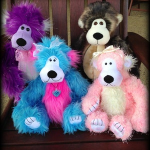 May include: Four plush stuffed animals sitting on a wooden chair. The animals are a purple, a blue and pink, a brown and white, and a pink and white.