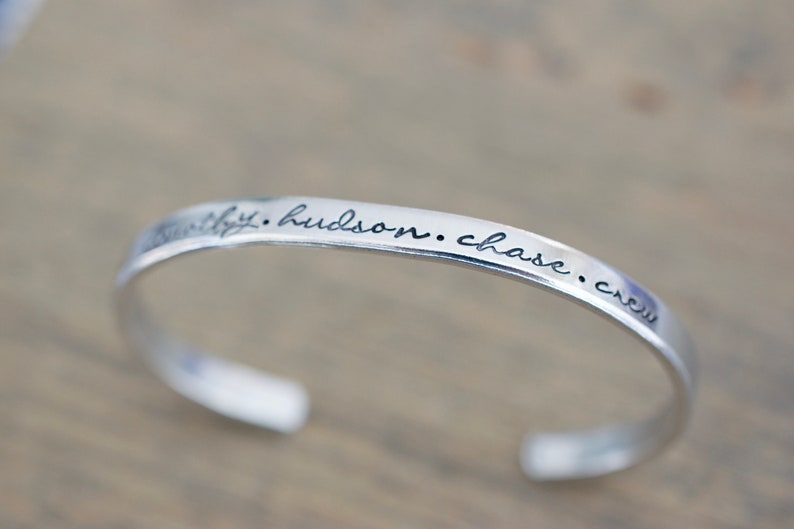 May include: Silver bangle bracelet with the inscription "faithfully. hudson. chase. crew" engraved on the band.