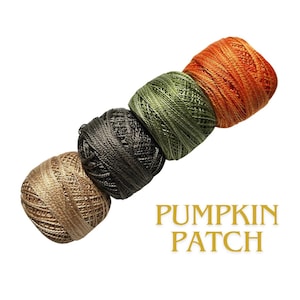 May include: Four spools of thread in a row, each a different color: tan, dark gray, olive green, and orange. The text "PUMPKIN PATCH" is in gold script below the spools. The thread is likely for crafting.