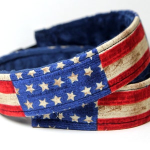 May include: Two fabric headbands with a red, white, and blue American flag pattern. The headbands are made of a soft, blue fabric with a white and red star pattern.