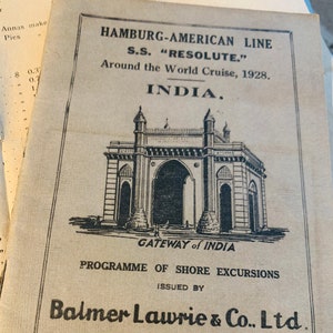 May include: A black and white image of the Gateway of India, a historic arch in Mumbai, India. The image is from a brochure for a shore excursion program issued by Balmer Lawrie & Co. Ltd., agents in Bombay and Calcutta. The text reads "Hamburg-American Line S.S. "RESOLUTE." Around the World Cruise, 1928. INDIA. GATEWAY of INDIA PROGRAMME OF SHORE EXCURSIONS ISSUED BY Balmer Lawrie & Co. Ltd. AGENTS BOMBAY AND CALCUTTA. BRITISH INDIA PRESS, BOMBAY."