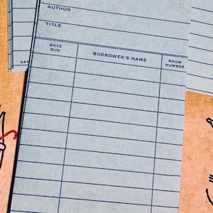 May include: Stack of light blue library cards with printed lines and text fields for author, title, date due, borrower's name, and room number. The cards have a vintage aesthetic.