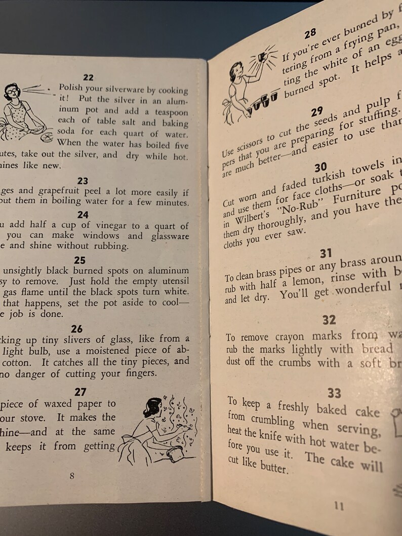 May include: A vintage book with illustrated tips for cleaning and homemaking. The book has numbered sections with titles like "Polish your silverware" and "To keep a freshly baked cake from crumbling".