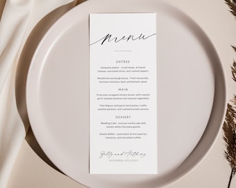 Peut inclure: Une carte de menu de mariage avec un design noir et blanc. Le menu comprend des entrées, des plats principaux et des desserts. La carte est sur une assiette blanche avec un fond brun. Le texte sur la carte est "Menu", "Entrée", "Assiette d'antipasti", "Pizzas au levain cuites au feu de bois", "Plat principal", "Poitrine de poulet enveloppée de prosciutto", "Filet Mignon", "Dessert", "Gâteau de mariage", "Buffet de sucreries", "Sally et Anthony", "10 novembre 20XX".