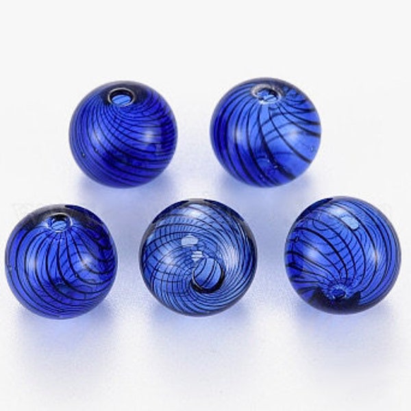 May include: Five round, cobalt blue glass beads with a swirling, dark blue pattern. Each bead has a small hole for stringing. The beads are evenly spaced against a white background.
