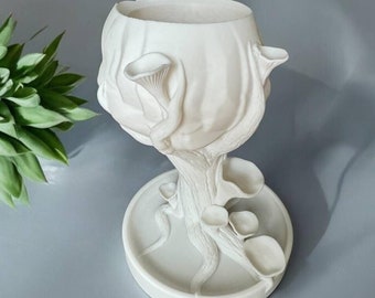 May include: White ceramic planter shaped like a mushroom with a wide, shallow bowl on top and a base with several smaller mushroom-shaped details.