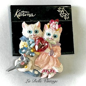 May include: A set of three ceramic mugs with a speckled, matte finish. The mugs are in shades of cream, light gray, and dark gray. Each mug has a simple, minimalist design, perfect for coffee or tea.