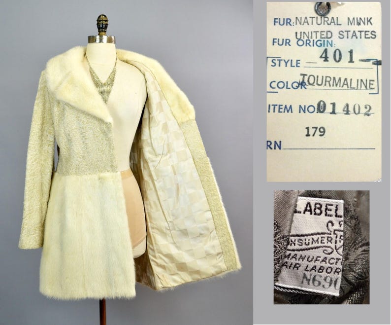 May include: A white fur coat with a shawl collar. The coat is lined with a white fabric. The label on the coat reads "FUR: NATURAL MINK, UNITED STATES FUR ORIGIN: 401, STYLE TOURMALINE, COLOR TOURMALINE, ITEM NO 01402, 179 RN". A smaller label reads "LABEL, CONSUMER, MANUFACT, AIR LABOR, N690".